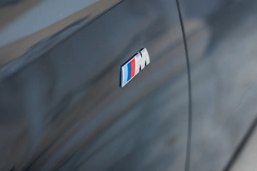 Emblema M na carroçaria do automóvel, em grande plano
