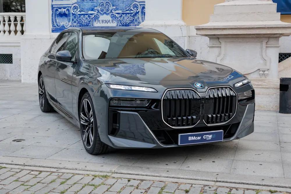 BMW Série 7 exposto no pátio empedrado do palácio