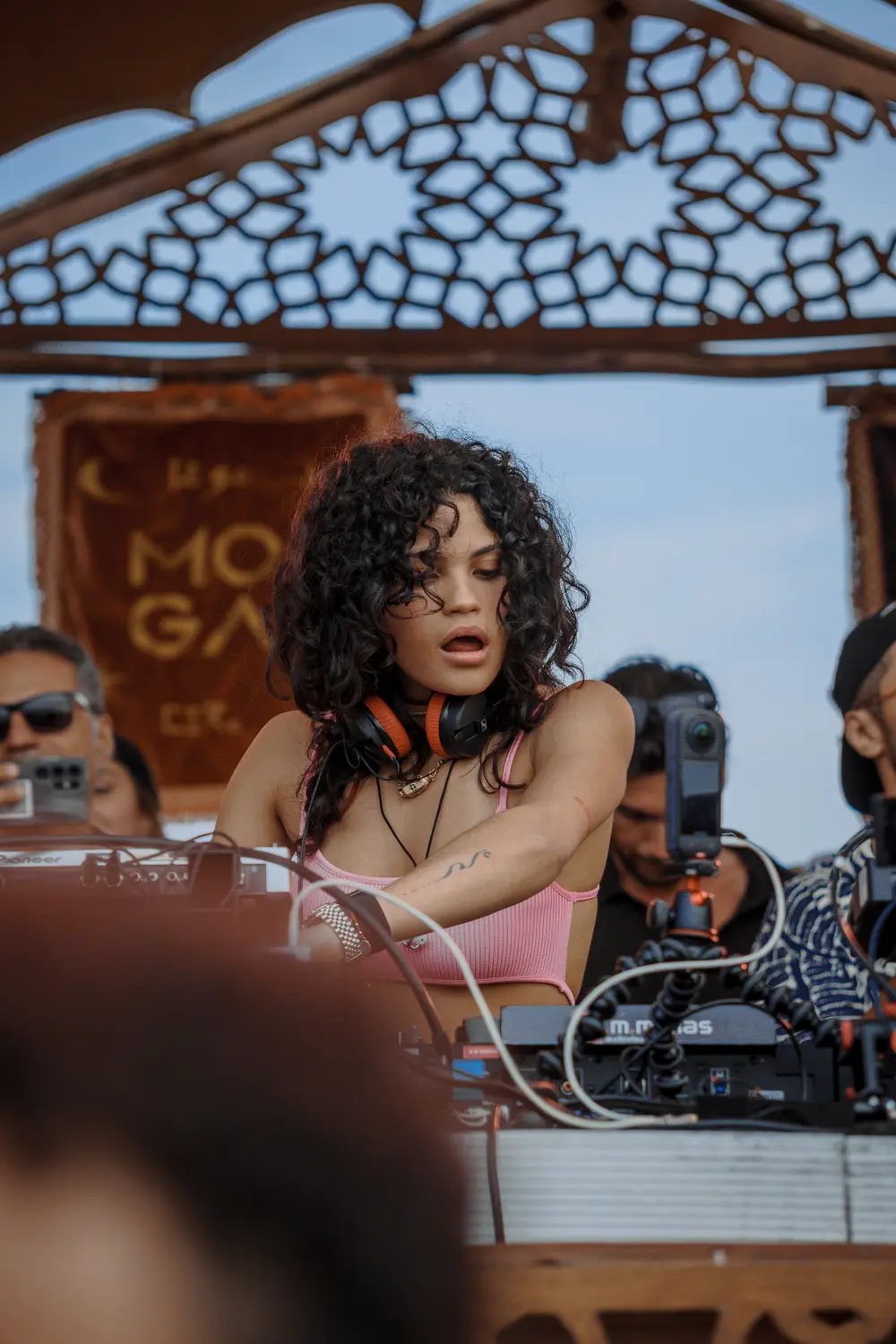 DJ a atuar na cabine, com o público em redor